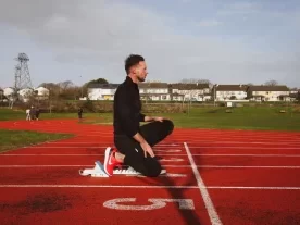 Personal trainer in Galway performing kettlebell press in Galway City Gym, demonstrating correct form and strength during a personal training session, Jason Cafferkey.
